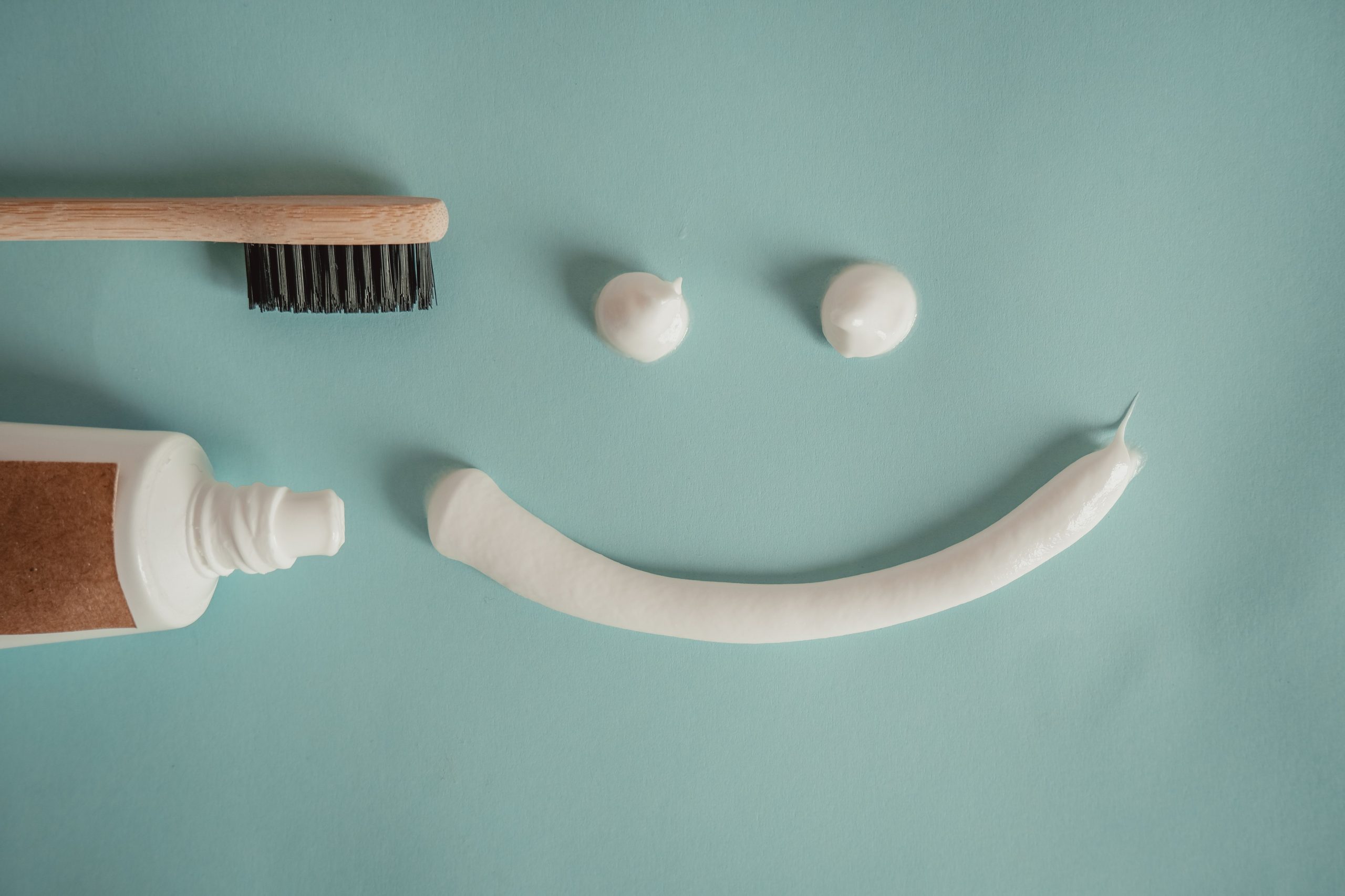 toothbrush and toothpaste forming a smile